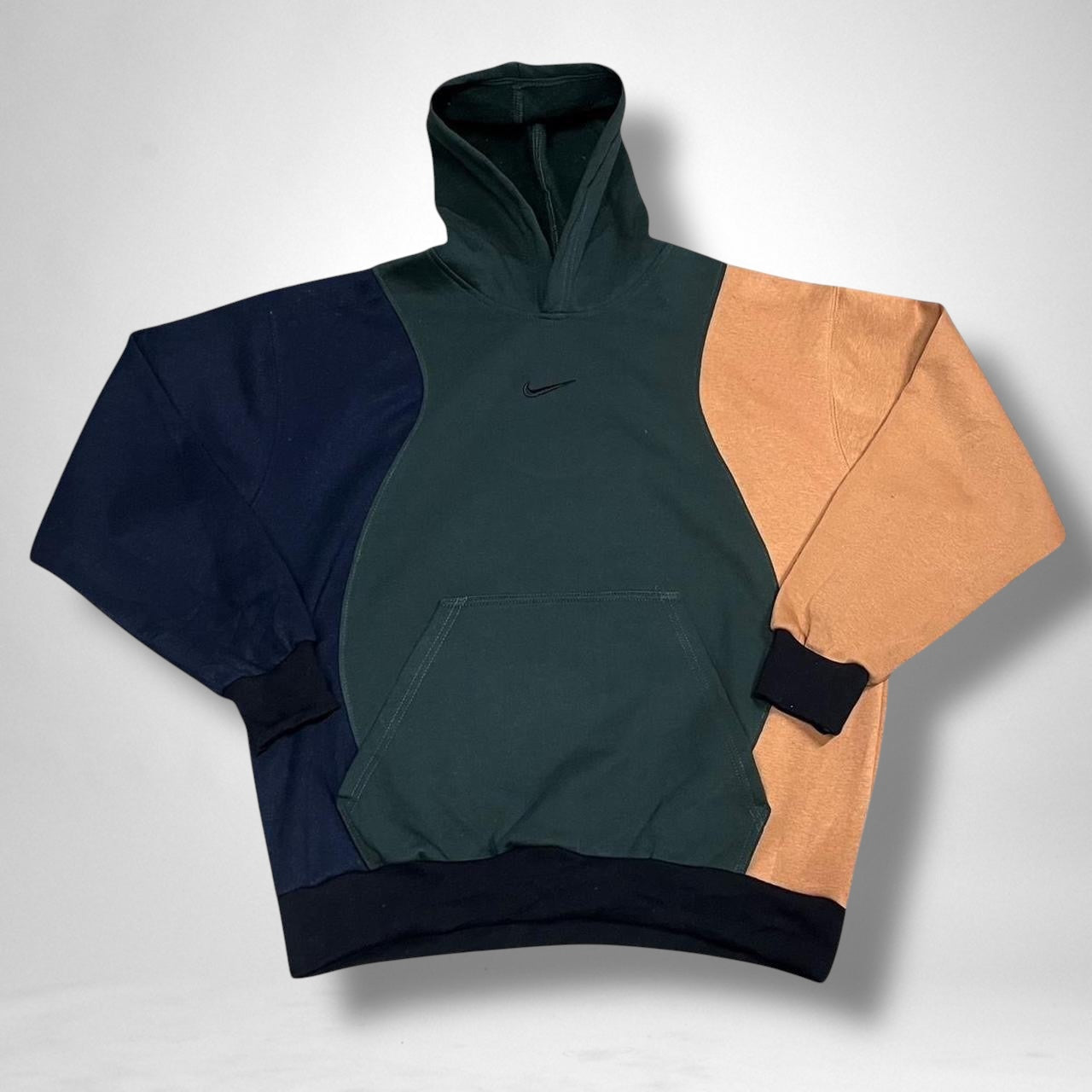 Reworked Nike hoodie in navy, khaki, and brown with vintage patchwork design and streetwear style