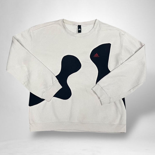 Crafted from authentic adidas materials, this reworked vintage jumper features the classic 3-Stripes detail, a bold embroidered adidas logo, and a relaxed oversized fit for ultimate comfort. The black and cream contrast gives it a sleek, monochrome aesthetic – perfect for layering or standing out solo.