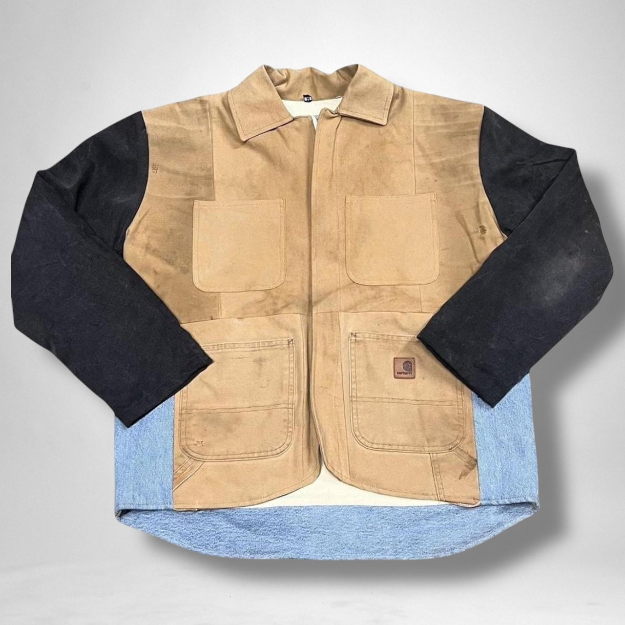 Reworked Carhartt jacket combining vintage utility style with modern streetwear elements.